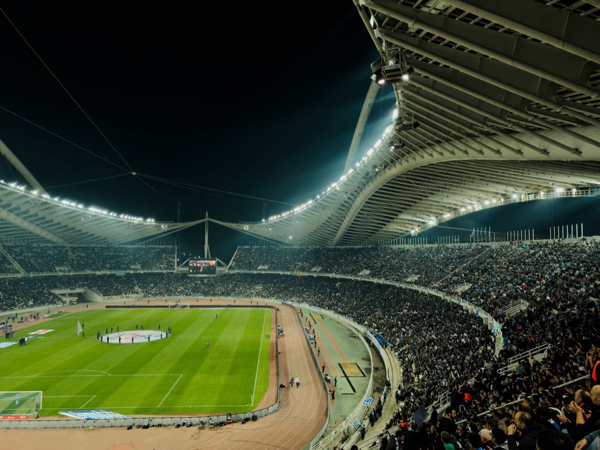 A professional football stadium under bright floodlights