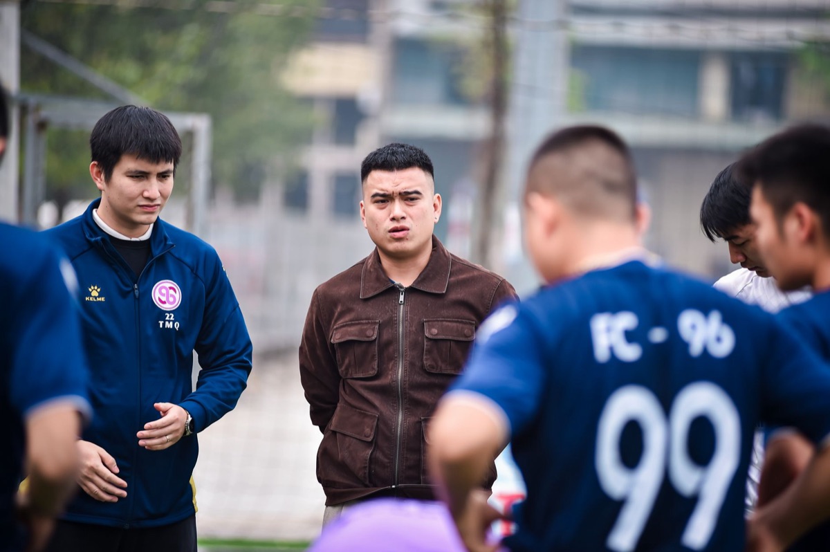 Soccer coach and team strategy meeting