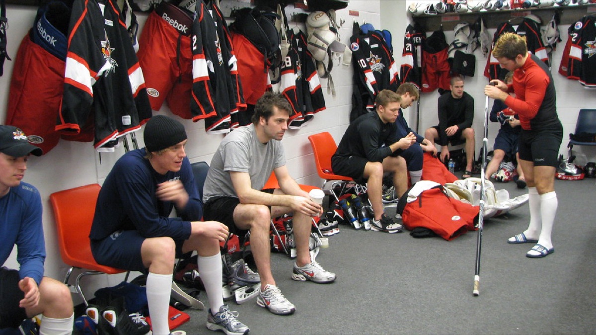 soccer team locker room with players and equipment