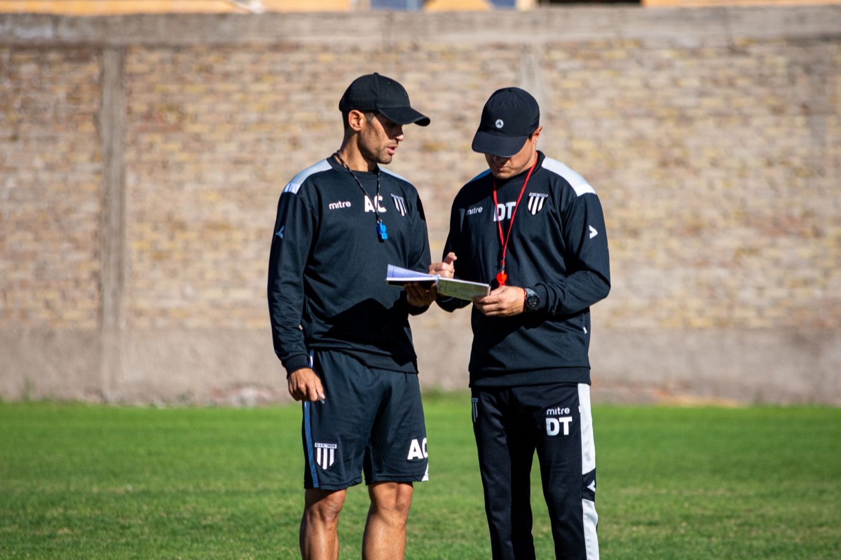 soccer team coach analyzing data on laptop