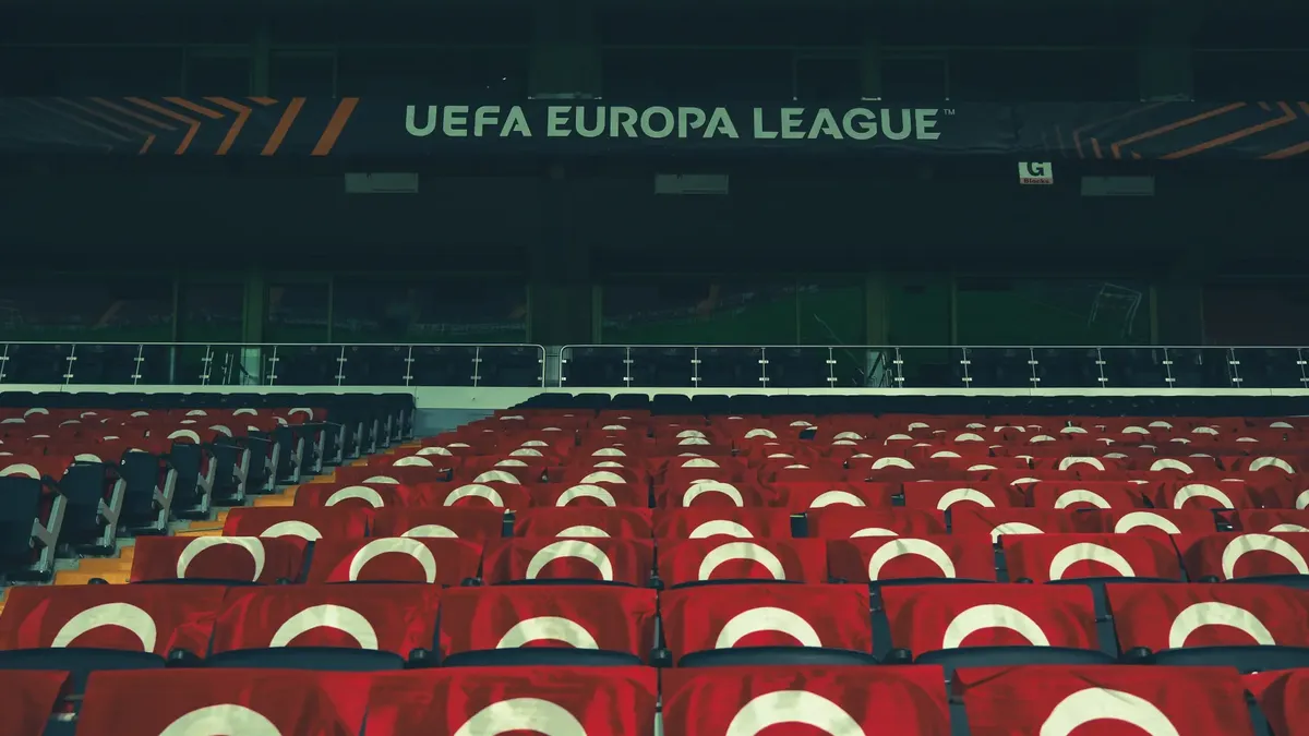 Rows of empty stadium seats adorned with UEFA Europa League banners, creating a sporting event atmosphere.