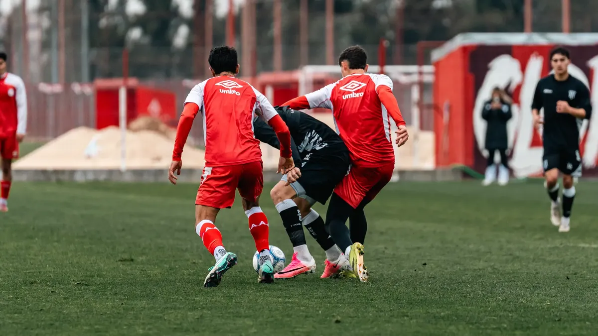 Competitive soccer game with players in action, showcasing teamwork and skill.